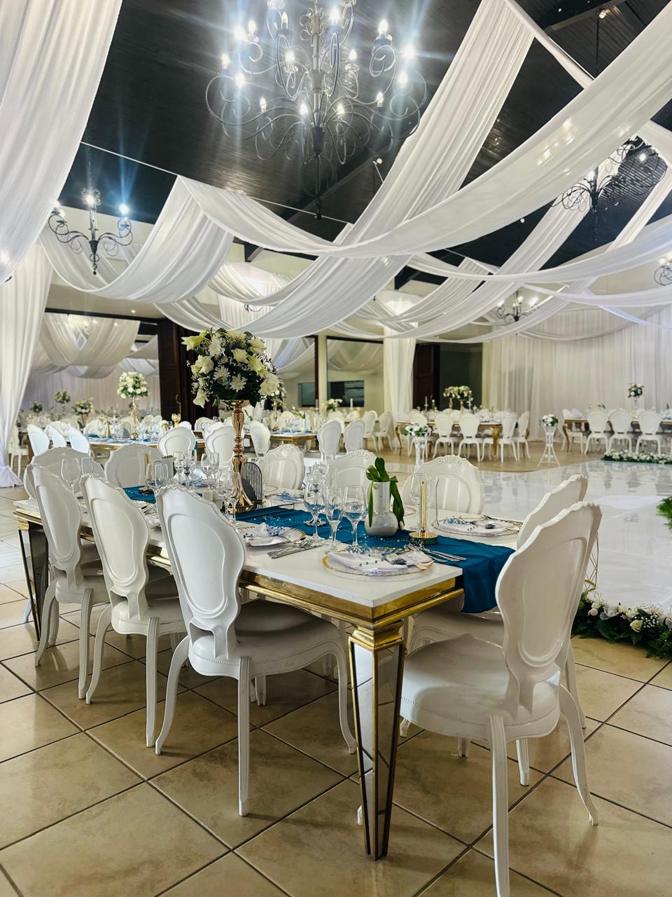 Draped reception hall with teal table settings